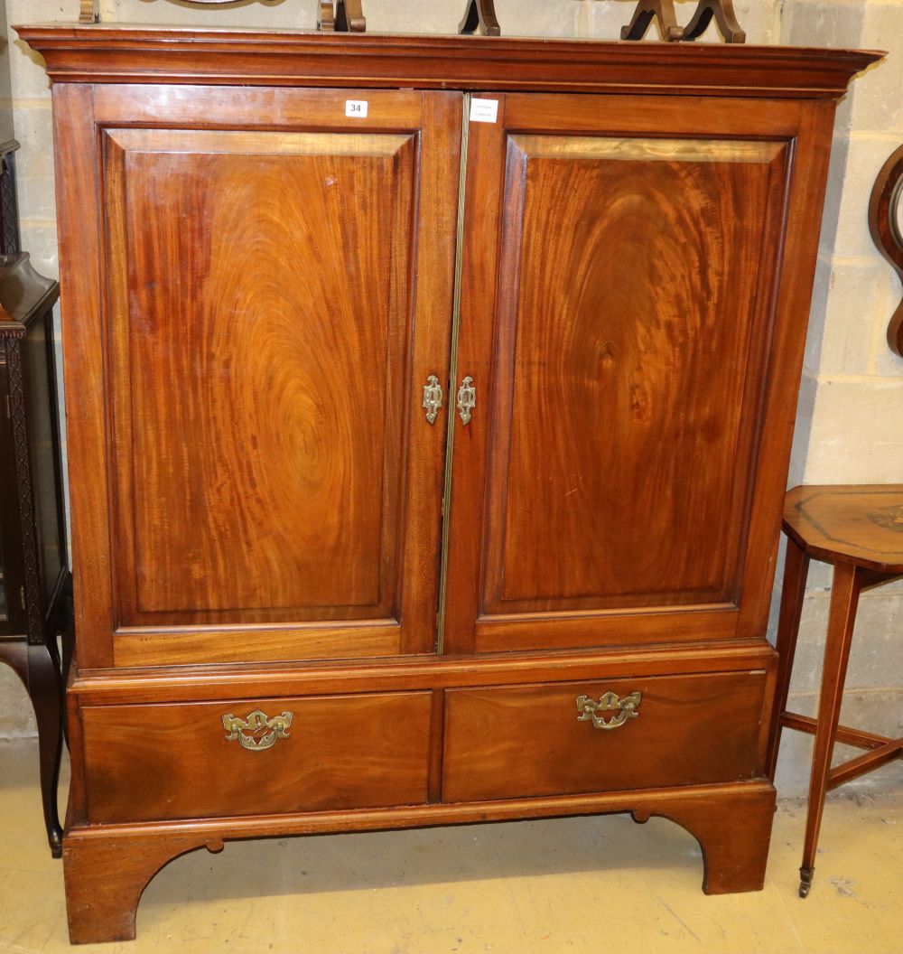 An early 19th century mahogany linen press, the top with a pair of fielded panelled doors over two small drawers, W.129cm, H.151cm